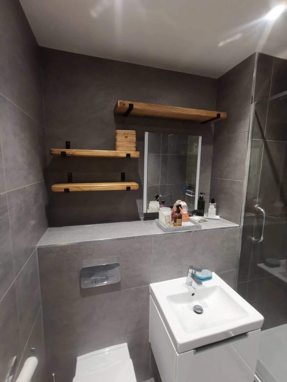 Oak shelves, grey tile — bathroom renovation by AdiDeccor, West Lothian