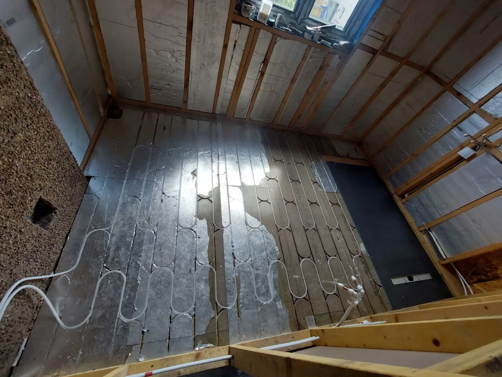 Insulated timber floor with wet underfloor heating pipework