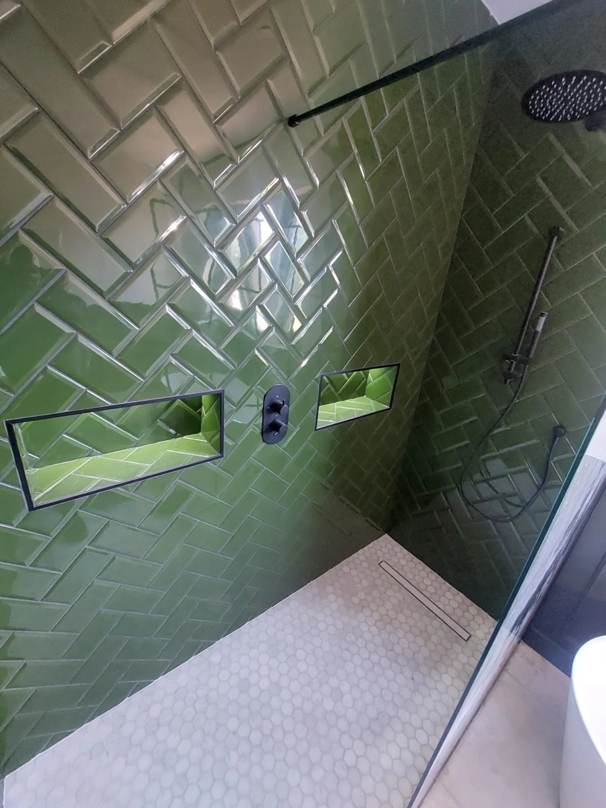 Green herringbone walk-in shower — AdiDeccor bathroom project