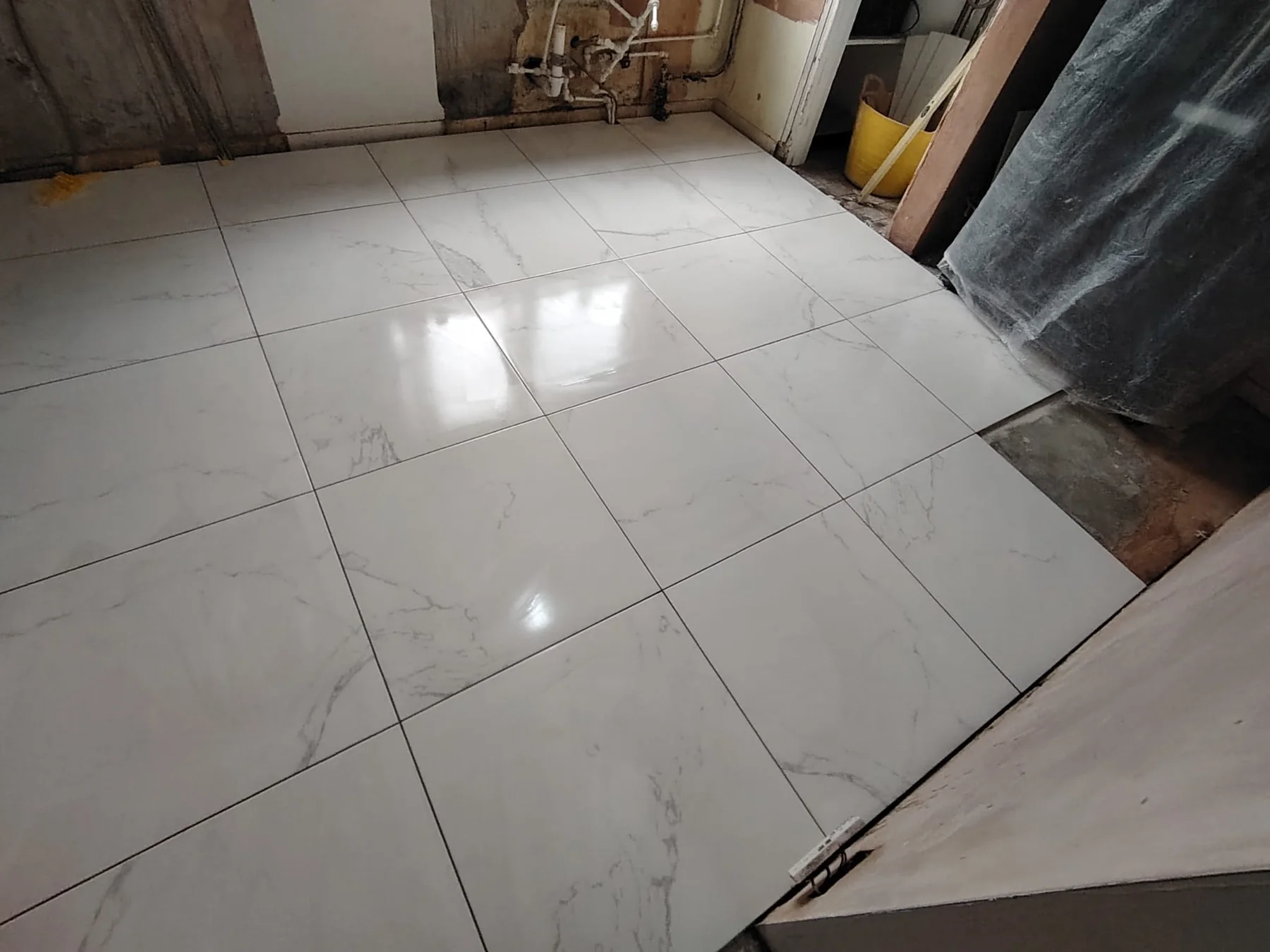 Large marble-effect porcelain floor tiles in a renovated bathroom